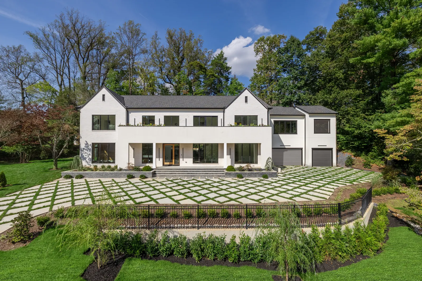 Front of the house with paver motor court and landscaped terrace