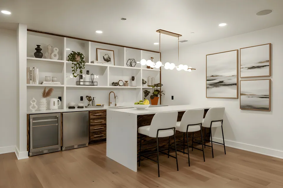 Lower-level wet bar with open shelving and seating