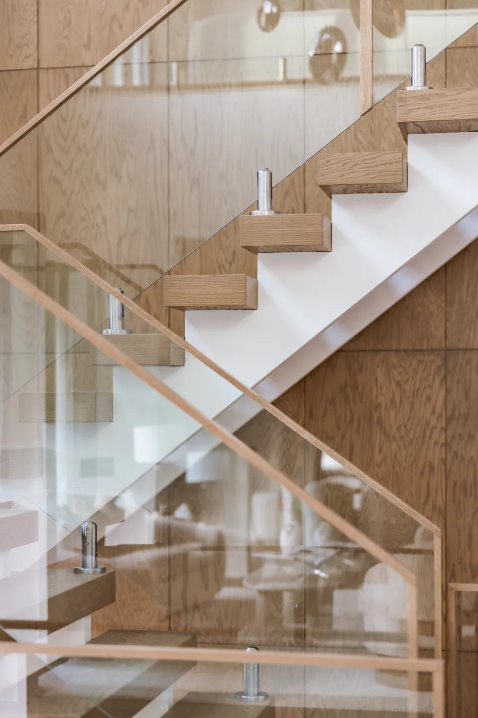 Staircase with glass railing and oak treads