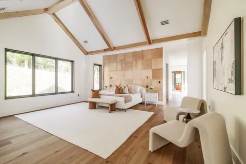 Primary bedroom with vaulted ceiling