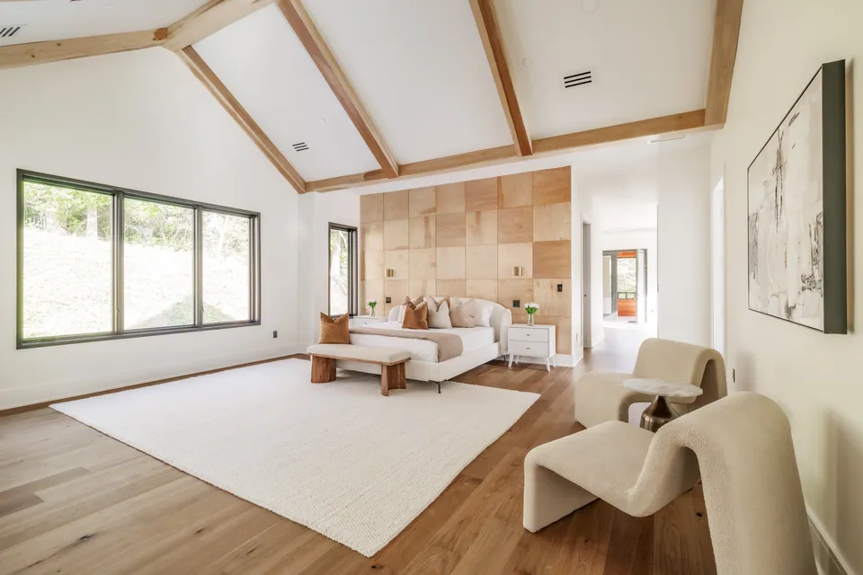 Primary bedroom with vaulted ceiling