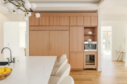 Kitchen with wood-paneled appliance wall