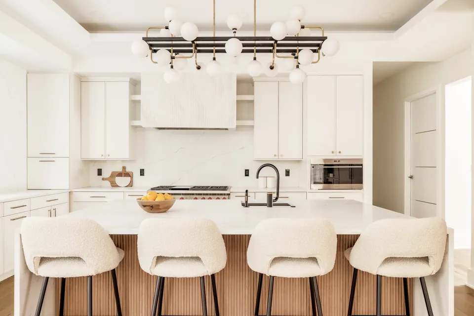 Kitchen with island seating and white cabinetry